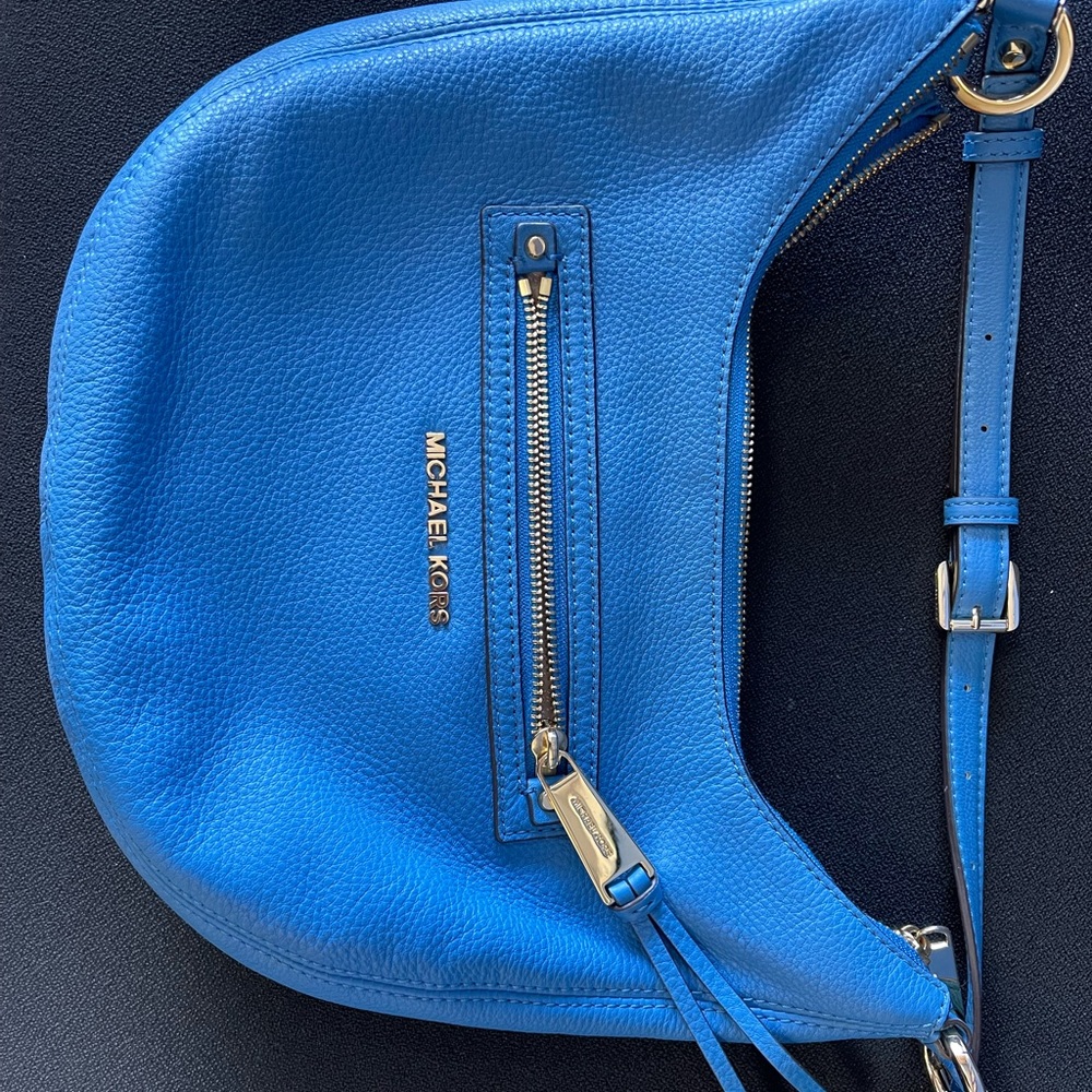 Only used a couple times . Beautiful blue MK crossbody